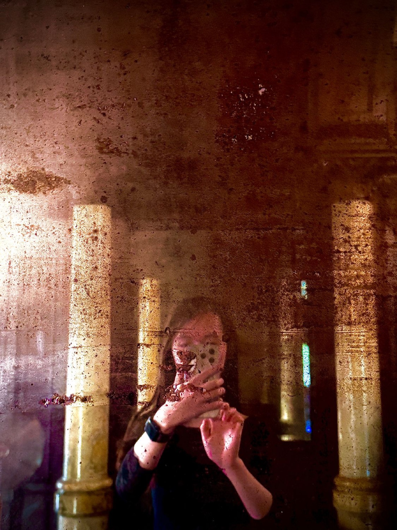 Self-portrait in an antique mirror